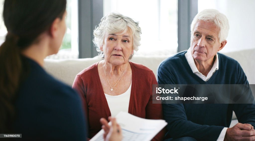 Shot of a senior couple meeting with a consultant to discuss paperwork at home